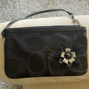 Preloved Coach Wristlet with rose detailing. 
Color: Black

One size